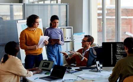 IT professionals discussing an insurance project in a meeting room