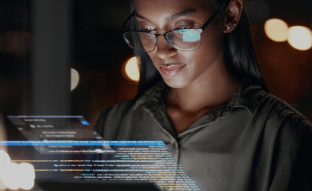 A female engineer is analyzing the code on a screen