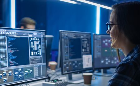 A female engineer is writing code on her computer