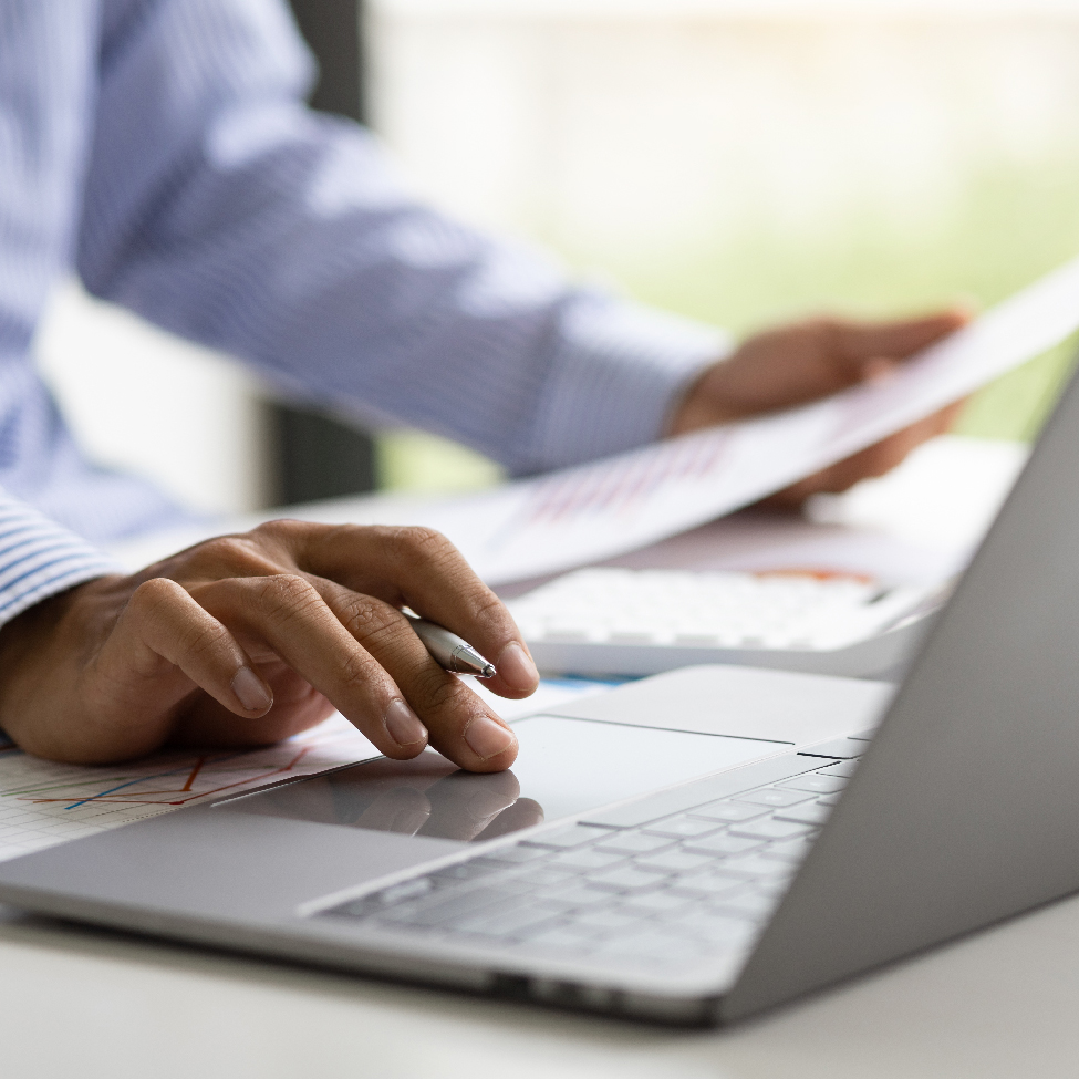 Close up of a person’s hands using a laptop