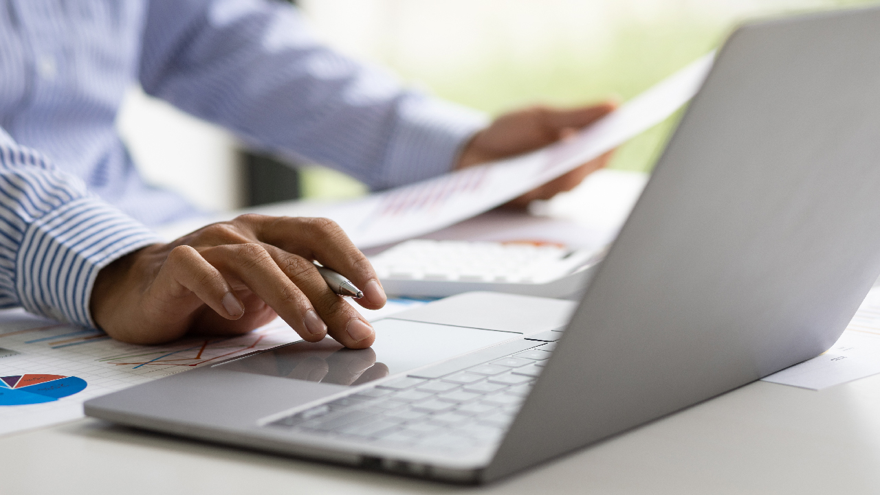 Close up of a person’s hands using a laptop