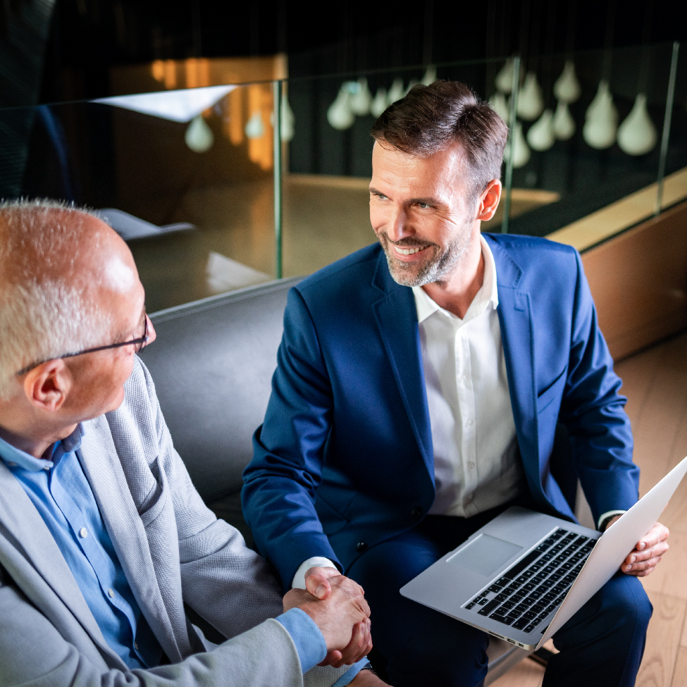 Two finance leaders are shaking hands in partnership