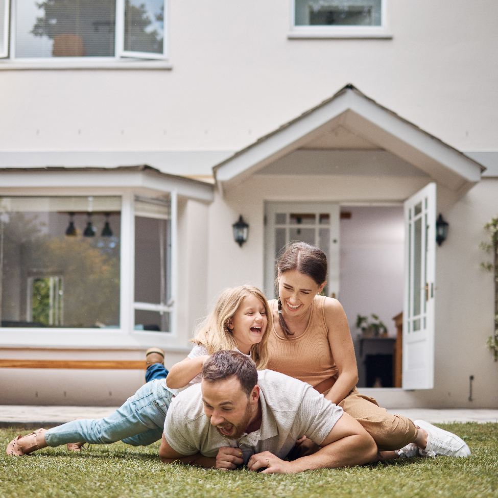 A family is spending quality time in the garden outside their home