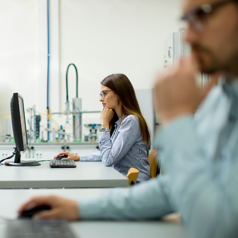 A female IT professional working on her computer in an office setting