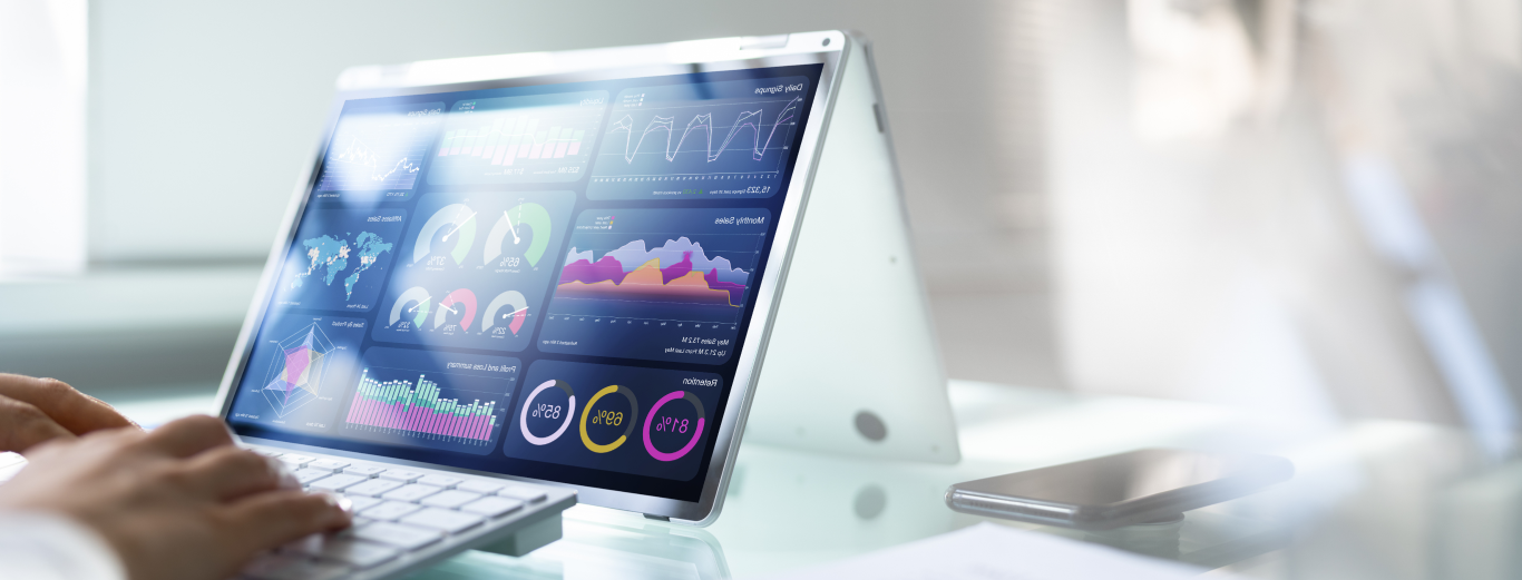 Close up of a laptop displaying a vision board with charts, infographics, percentages, and maps for an advanced analytics project