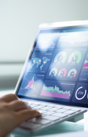 Close up of a laptop displaying a vision board with charts, infographics, percentages, and maps for an advanced analytics project