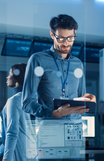 A male and a female IT professional are working in a computer laboratory