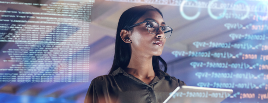 A female data and AI professional is analyzing data on a large computer screen